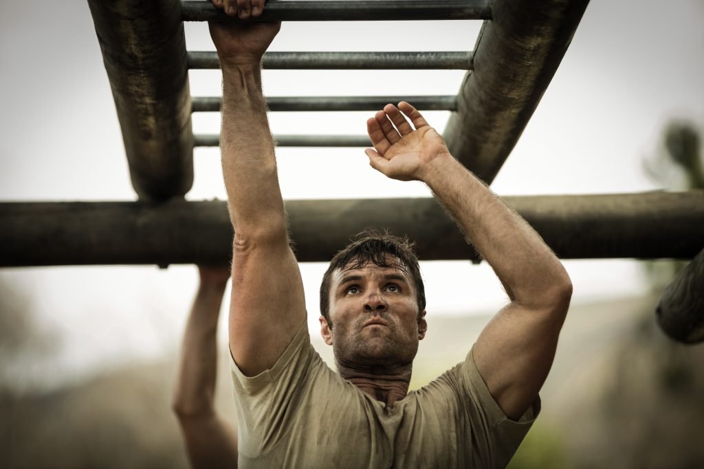 Soldier climbing monkey bars
