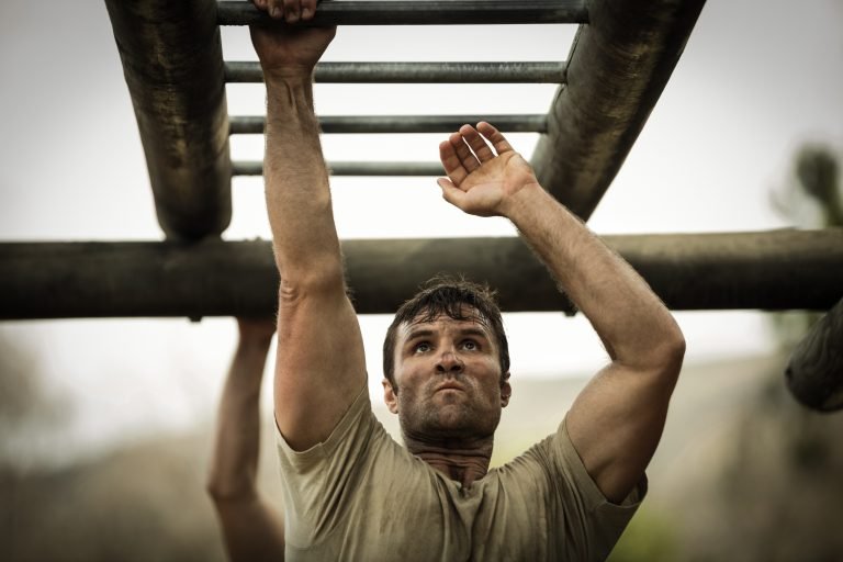 Soldier climbing monkey bars