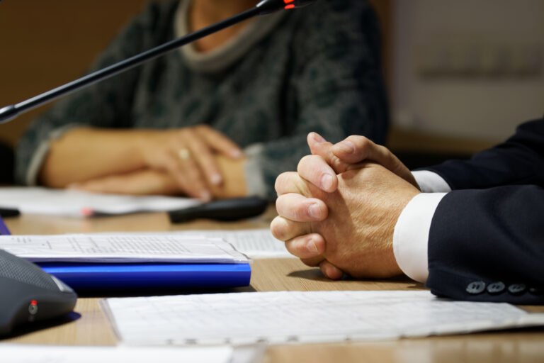 Hands of the boss during a meeting or discussion. Clenched finger