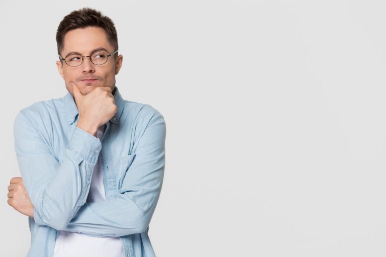 Thoughtful suspicious young man looking aside feeling skeptic
